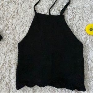 black crop top ties around the neck.